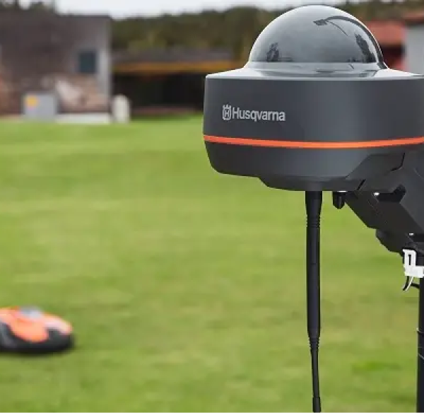 Husqvarna EPOS station with the greens and automower on the background