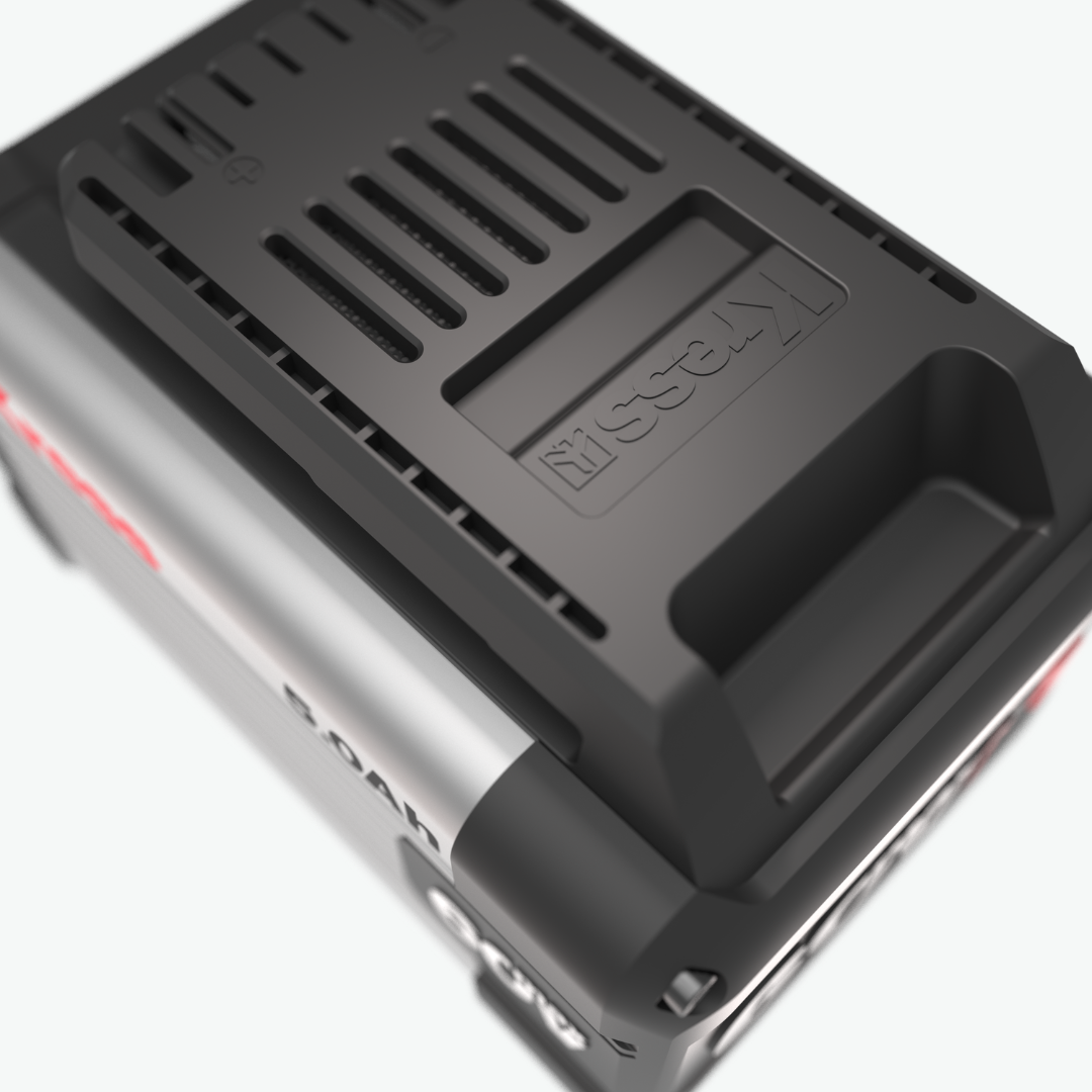A close-up of a black and silver battery charger or power adapter with a ribbed black top surface and the brand name 'Kress' embossed on it, set against a clean white background.